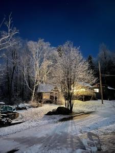 a house in the snow at night at B10 NEW Awesome Tiny Home with AC Mountain Views Minutes to Skiing Hiking Attractions in Carroll