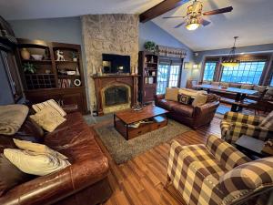a living room with a couch and a fireplace at FC17 Stylishly renovated Forest Cottage walk to Bretton Woods ski trails wifi cable ping pong in Carroll