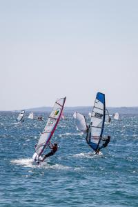 a group of people windsurfing in the ocean at Les Voiles d'Azur in La Londe-les-Maures