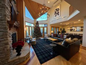 a living room with a fireplace and a christmas tree at CR1 Top Rated Ski-In Ski-Out Townhome Great views fireplaces fast wifi AC - Short walk to slopes in Carroll