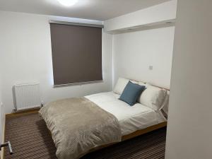 a bedroom with a bed with a large window at Stunning Cozy Flat. in Kent