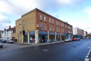 a brick building on the side of a city street at MR2 - Fantastic 1 Bed apartment Munster Village in London