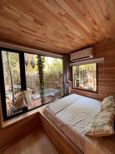 a bedroom with a bed and a large window at La Casita- imawi in Belén de Escobar +42 photos