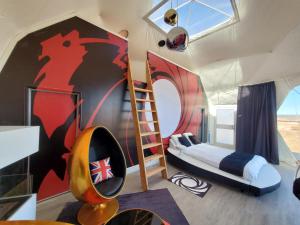 a bedroom with a bed and a wall with a mural at Clear Sky Resorts - Grand Canyon - Unique Sky Domes in Valle