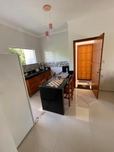 a kitchen with a island in the middle of a room at P&M'S Porto Seguro Taperapuan in Porto Seguro