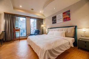 Voodi või voodid majutusasutuse Wenpin Hotel - Pier 2 toas