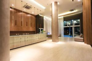 a large room with a kitchen with wooden cabinets at Quarto Executivo para Sua Estadia de Trabalho in Campos dos Goytacazes