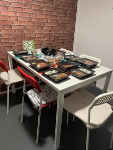 a table with a tray of food on it at Pokoje Gościnne FRESCO in Łódź