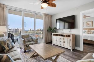 a living room with a bed and a tv at Pelican Beach Terrace 805 in Destin