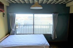 a bedroom with a bed and a large window at Condo within Tokyo DisneyResort 10 people can stay in Tokyo