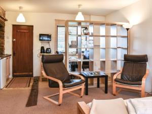 a living room with two chairs and a table at Jims Place - Uk42085 in Sedbergh
