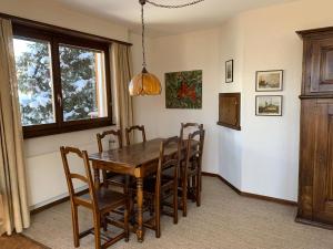 a dining room with a wooden table and chairs at Peak-view Crans-Montana in Crans-Montana