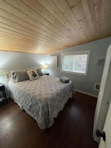 a bedroom with a large bed with a wooden ceiling at Our Cozy Getaway in Ocean Park