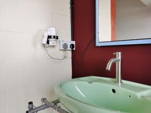 a bathroom with a sink and a mirror at Walk-Up To SIAR - Children Not Allowed in Cameron Highlands