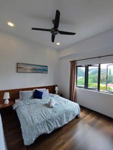 a bedroom with a bed and a ceiling fan at Muji Homestay @ The Retreat, Cameron Highlands in Cameron Highlands +34 photos
