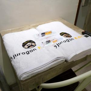 a pile of towels sitting on a table at Djuragan Kamar Mangga Besar in Jakarta