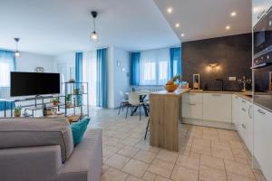 a kitchen and living room with a couch and a table at Luxe Blue in Šmrika