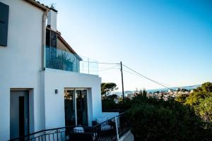Cette chambre offre une vue sur une maison blanche dotée d'un balcon. dans l'établissement Les Balcons du Roucas Blanc, à Marseille