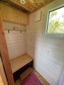 a small room in a tiny house with a window at Tiny house au cœur du bocage in Landelles-et-Coupigny