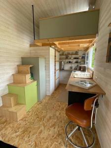 a room with a desk and a chair in a house at Tiny house au cœur du bocage in Landelles-et-Coupigny