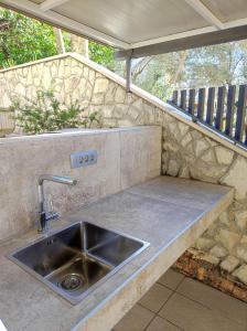 a kitchen with a sink and a counter top at apartman Emili in Malinska