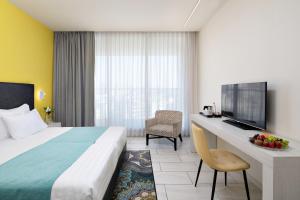 מיטה או מיטות בחדר ב-לגאסי - מלון ומרכז כנסים נצרת