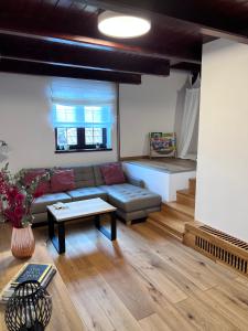 a living room with a couch and a bed at Apartmán na Pasekách in Bystrzyca