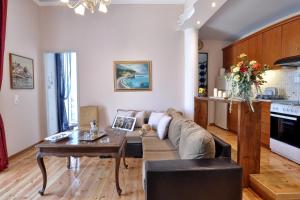 a living room with a couch and a table at Anesis Apartment Corfu Town in Corfu Town