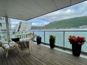 a balcony with a view of the water at Sea View City Apartment in Tromsø