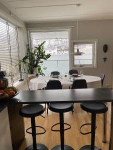 a dining room with a table and some chairs at Sea View City Apartment in Tromsø