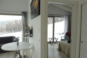 a living room with a table and a window at B&B Tantané in Torgnon