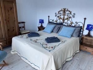 a bedroom with a bed with blue pillows on it at B&B Tantané in Torgnon