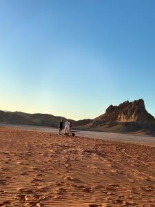 a group of people walking in the desert at bedouin future camp in Wadi Rum