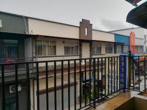 a balcony of a building with a fence at MnD Lodge in Semporna