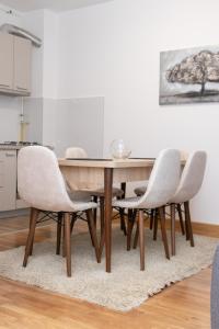 a dining room with a table and chairs at Millennium Apartment in Bačka Palanka