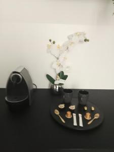 a black table with a plate of food and a speaker at The Manhattan Luxury suite in Jumet +24 photos