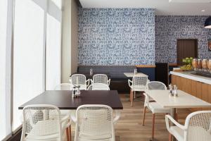 a dining room with white chairs and tables at TownePlace Suites by Marriott New Orleans Downtown/Canal Street in New Orleans