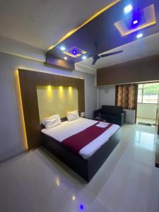 a bedroom with a large bed in a room at Redbell Suites Calicut in Kozhikode