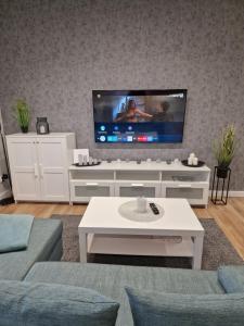 a living room with a flat screen tv on a wall at Apartament na Letniej z garażem "Domowe Zacisze" in Kłodzko