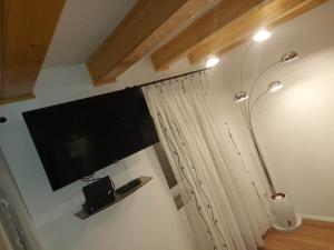 a flat screen tv on the wall of a room at VitaminSea - Lovran in Lovran