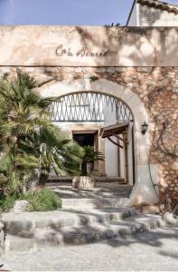 an entrance to a building with a stone walkway at Finca Can Beneit in Binibona