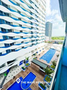 an aerial view of a large building with a swimming pool at Cardamom The Wave&Atlantis Residence Melaka Town in Melaka