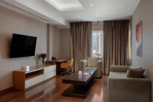 a living room with a couch and a tv at Ramada by Wyndham Erbil Gulan Street in Erbil