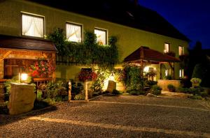 a house with flowers and lights in front of it at Appartement`s - HAUS KAROLA in Bad Schandau