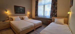 Cama o camas de una habitación en Alliance Hotel Ieper Centrum