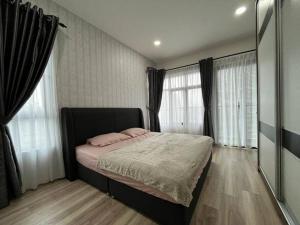 a bedroom with a bed with two pink pillows on it at P Residence G.L Home Stay in Kuching