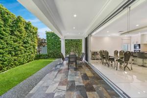 an indoor patio with a table and chairs and a garden at Swainson on Fawnbrake in Henley Beach South