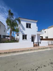 a white house on the side of a street at Villa Joia in Ayia Napa