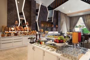 a breakfast buffet in a hotel room with food at Ramada by Wyndham Aligarh GT Road in Alīgarh