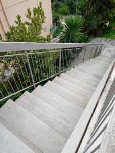 a set of concrete stairs with a metal railing at SUNNY APARTMENT NORTHERN ATHENS in Athens